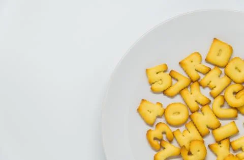 Alphabet cracker in dish with white background Stock Photos