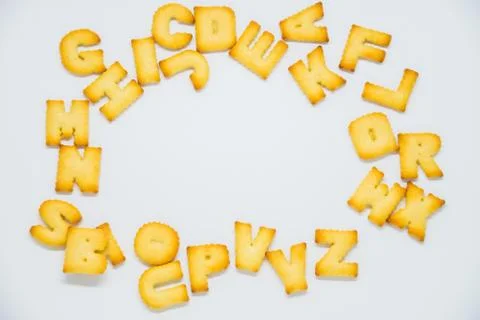 Alphabet cracker with space in the middle on white background Stock Photos