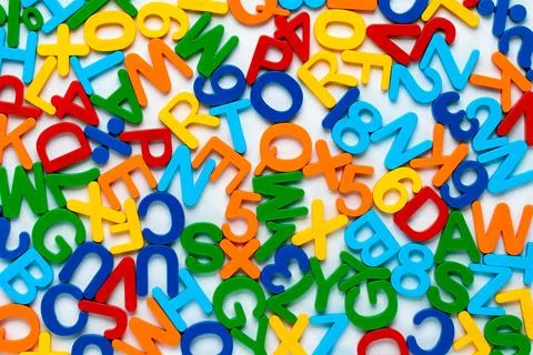 Alphabet, multicolor background with plastic numbers and letters. ABC. Educat Stock Photos