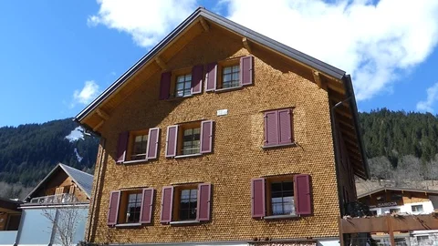 ALPINE BUILDING WITH MOUNTAIN Stock Footage 121450650