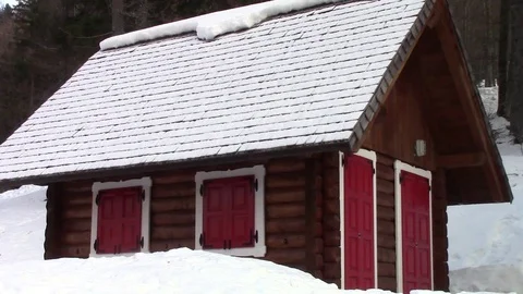 Alpine Chalet Cottage with red windows coverd by snow in quiet Stock Footage 112042642