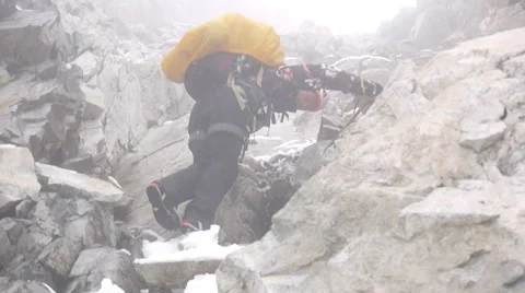 Alpine climber climbing down from the mountain Stock Footage 43248809