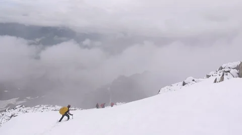 Alpine climber falling into hole in snow Stock Footage 43248794