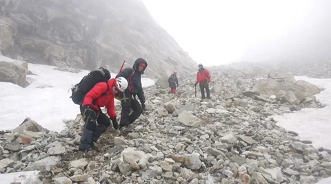 Alpine climbers descending through stone field Stock Footage 43248820