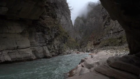 Alpine Creek Flowing Between Jagged Mountain Rocks Video stock 318900459