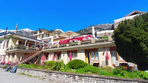 Alpine Hotel Terrace with Snow-Capped Mountains and Blue Sky, Switzerland 4K Stock Footage 341088704