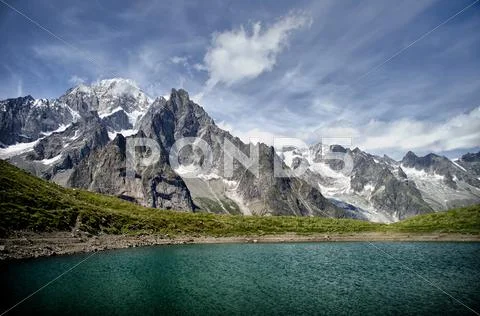 Alpine lake and mountain range Stock Photos