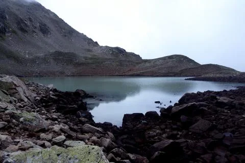 Alpine lake in the clouds. Stock Photos