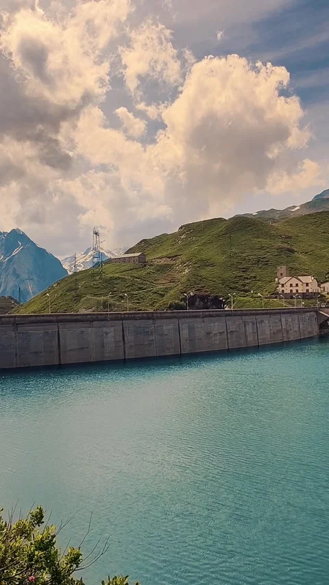 Alpine lake with dam View and Mountainous Background, Perfect For Travel and Stock Footage 315213365