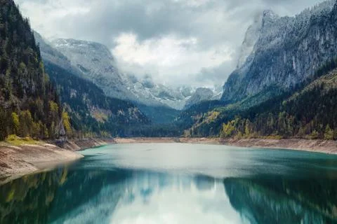 Alpine lake with dramatic sky and mountains Stock Photos