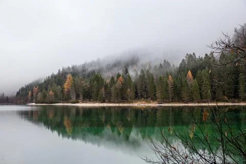 Alpine lake in foggy morning in mountains Stock Photos