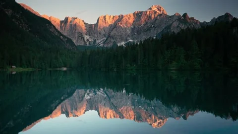 Alpine lake with a mountain backdrop at sunset Stock Footage 133061039