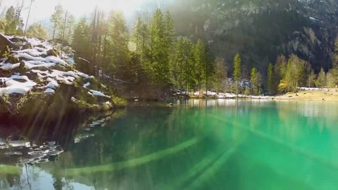 Alpine lake with spring sunlight, and trees. Stock Footage 306652682