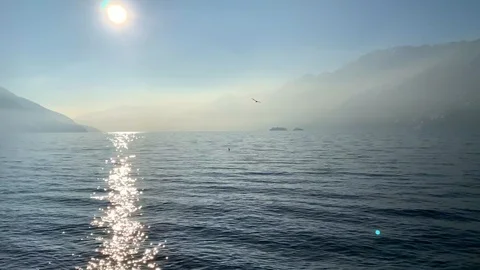 Alpine Lake with Sun Reflection and Mountain 動画素材 111324016