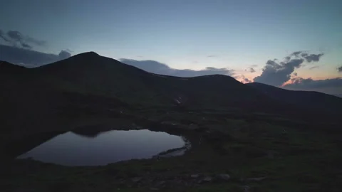 Alpine lake surrounded by mountains night time lapse zoom in Stock Footage 160771240