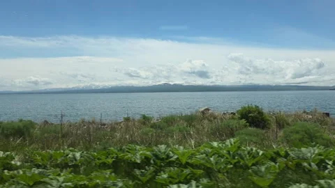 Alpine Lake with Vegetation and Mountain Sky,Sevan,Armenia Stock Footage 337469292