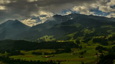 Alpine landscape in Berner Oberland fields and forest sunbeams Stock Footage 52219652
