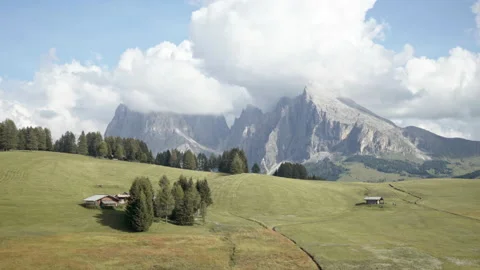 Alpine landscape with huts, trees, meadows and mountains - Seiser Alm, Dolomites Stock Footage 150407369