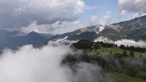Alpine landscape nature rolling hills clouds covered Switzerland outdoor retreat Video stock 345448379