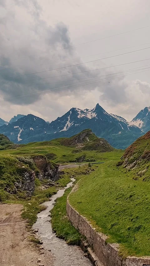 Alpine Landscape with Power Lines and Mountainous Background for Outdoor Video stock 313447218