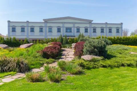 Alpine lawn with a path in front of a white two-story house Stock Photos
