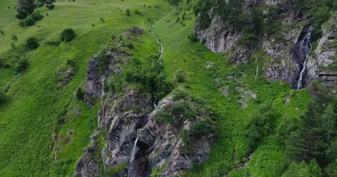 Alpine meadows in high mountains. Waterfall in the green mountains Stock Footage 170567422