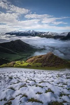Alpine meadows under snow in spring in the mountains at dawn, against the b.. Stock Photos