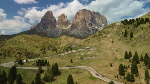 Alpine mountain landscape with winding road through green hills and peaks 動画素材 337076785