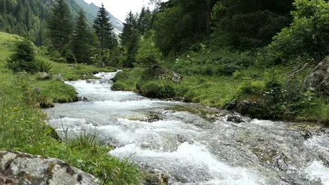 Alpine mountain river flowing through Schwarzachtal valley in Tirol Austria. 스톡 동영상 121370652