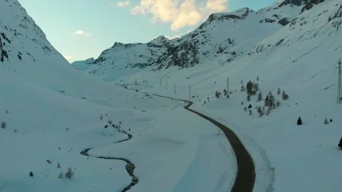 Alpine Mountain Road Through Snow-Covered Valley Stock Footage 341608049