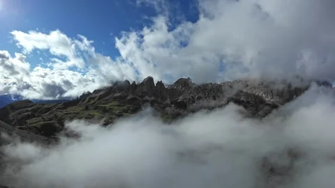Alpine mountain view, Drone captures breathtaking cloudcovered mountain summit Stock Footage 325753903