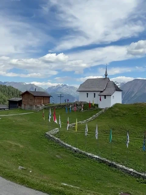 Alpine Mountain Village View with Chapel and Flags Stock-Footage 341317828