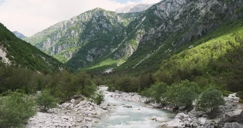 Alpine mountains and a river with a fast flow of water and blue water that flows Stock Footage 171727224