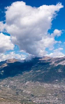 Alpine mountains with shadows of clouds Stock Photos