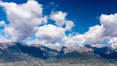 Alpine mountains with shadows of clouds Stock Photos