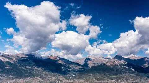 Alpine mountains with shadows of clouds Stock Photos