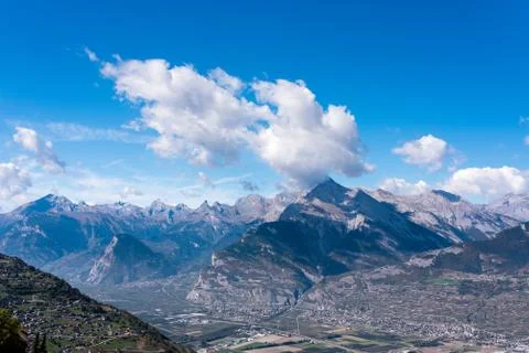 Alpine mountains with shadows of clouds Stock Photos