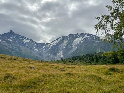 Alpine pasture under cloudy sky in Les Contamines-Montjoie, France Stock Photos