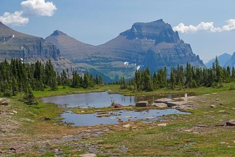 Alpine Pond With Dramatic Mountains in Its Background Stockfoto's
