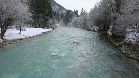 Alpine river flowing downstream in winter season Stock Footage 145533116