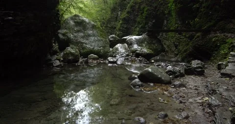 Alpine river flows through gorges carved by time Video stock 190593660