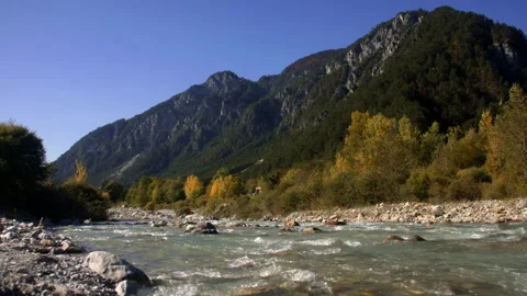 Alpine river surrounded by mountain range Stock Footage 258928428