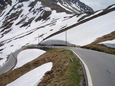Alpine road with snow Stock Photos