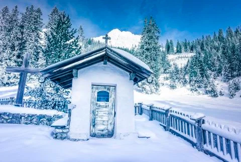 Alpine rustic chapel in winter decor Stock Photos