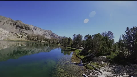 Alpine Shoreline FPV: Gliding Over Baptie Lake, Pioneer Mountains, Idaho Stock Footage 331898840