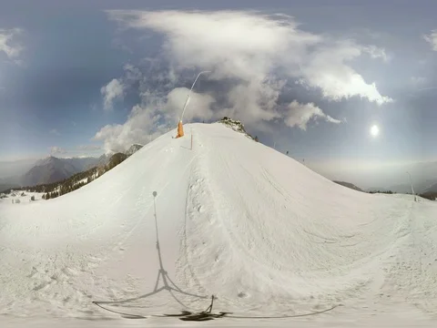 Alpine ski resort. Ski trail and skiers passing by. View of mountains and valley Stock Footage 77967246