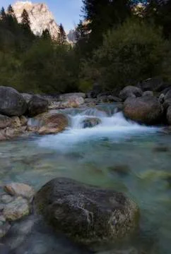Alpine torrent with a mountain in the background Stock Photos