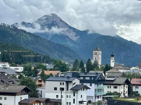 Alpine Town Mountain Peak Cloudy Sky Church Towers Foto stock