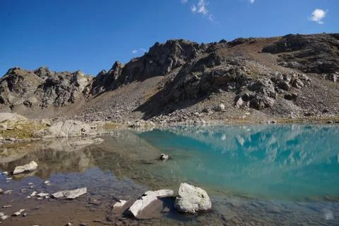 Alpine turquoise lake of Sofia, surrounded by rocks. Karachay-Cherkessia, Ark Stock Photos