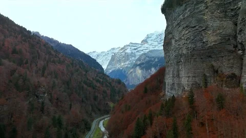 Alpine valley with autumn forests and snow-covered mountains Stock Footage 346323747